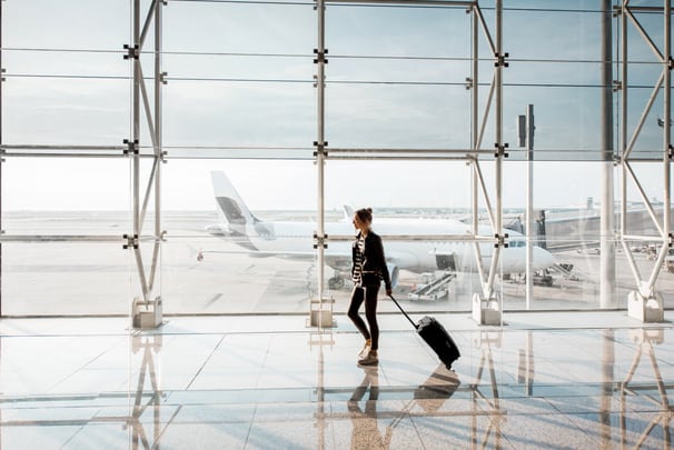 woman walking in a safe airport thanks to counter uas systems that keep airspace safe