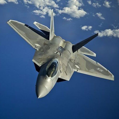 Military fighter plane flying nose down against a clear blue sky