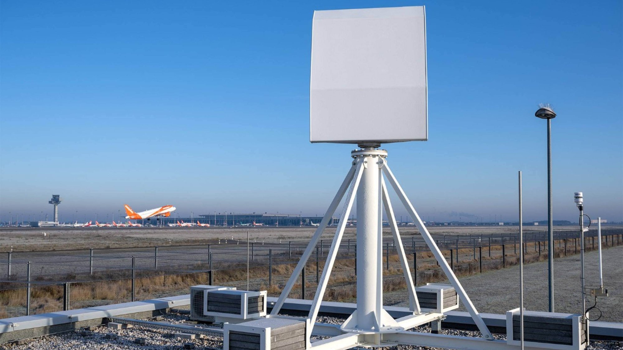 MAX bird detection radar mounted on top of a building at an airport