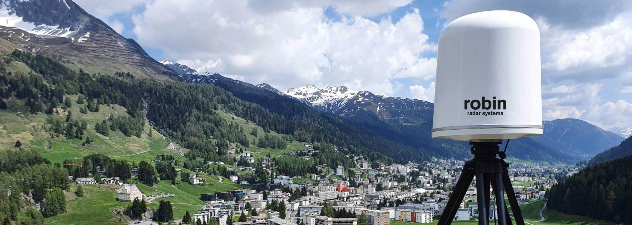 IRIS drone detection radar installed on a hillside overlooking an alpine town