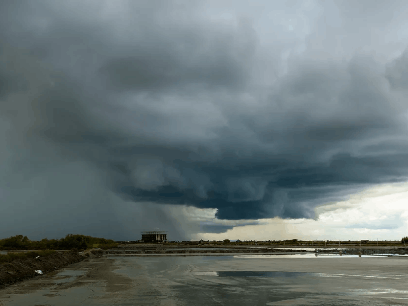Large storm clouds gathering over wetland