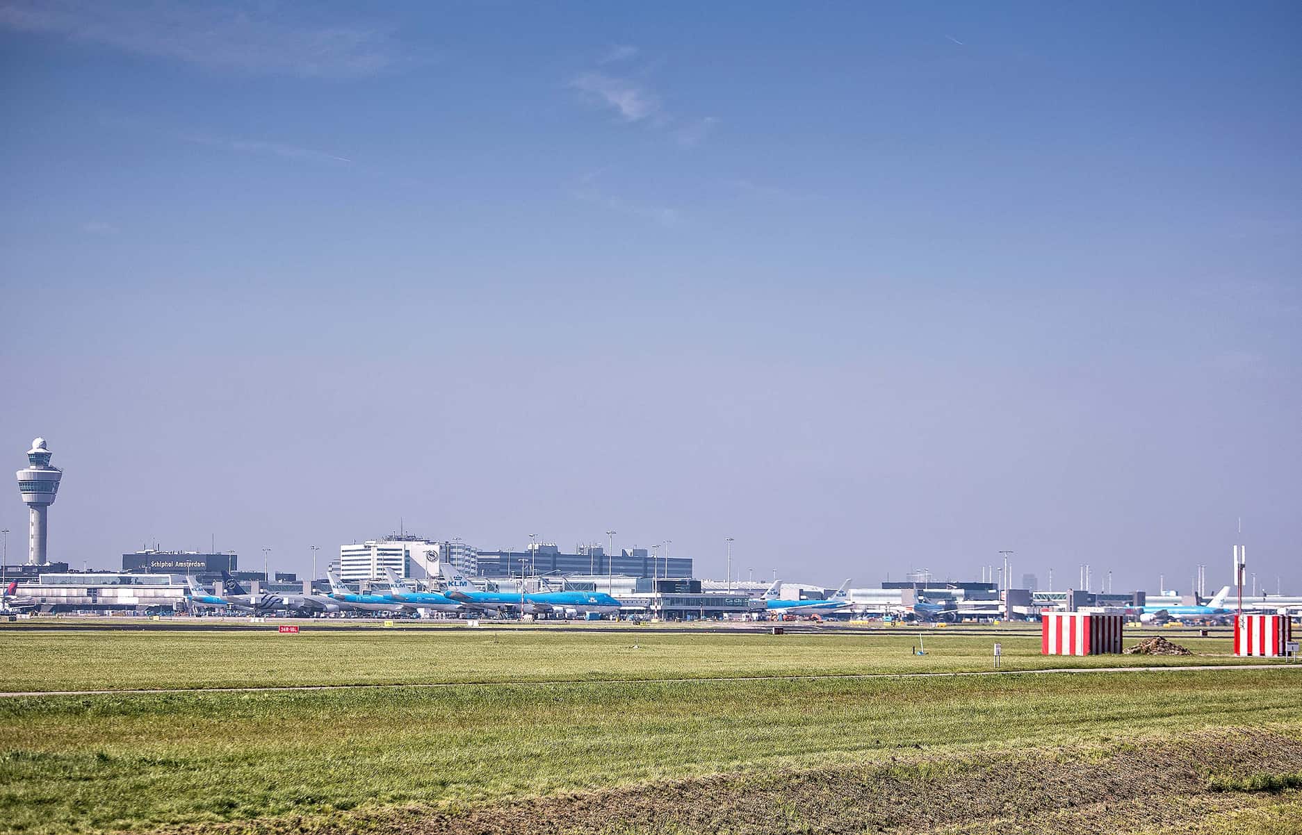 Wide-angle shot of Schiphol airport, showing multiple stationary planes